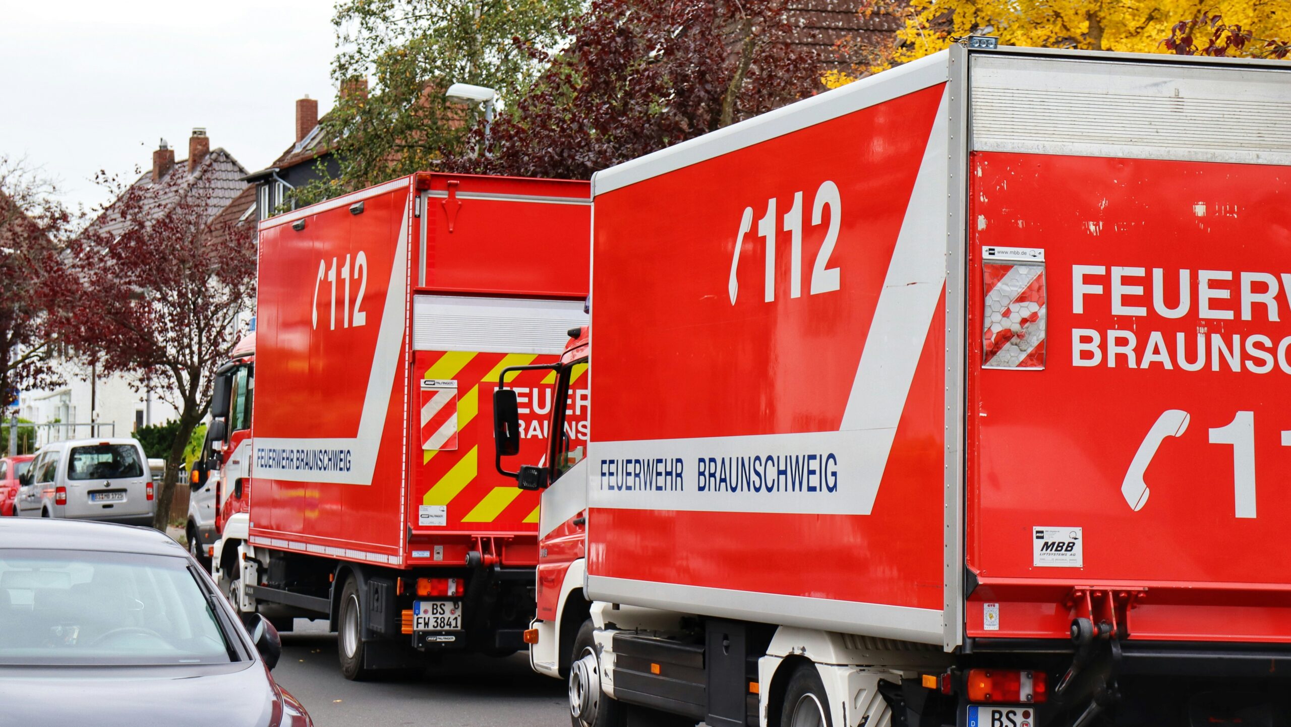 a red delivery truck driving down a street