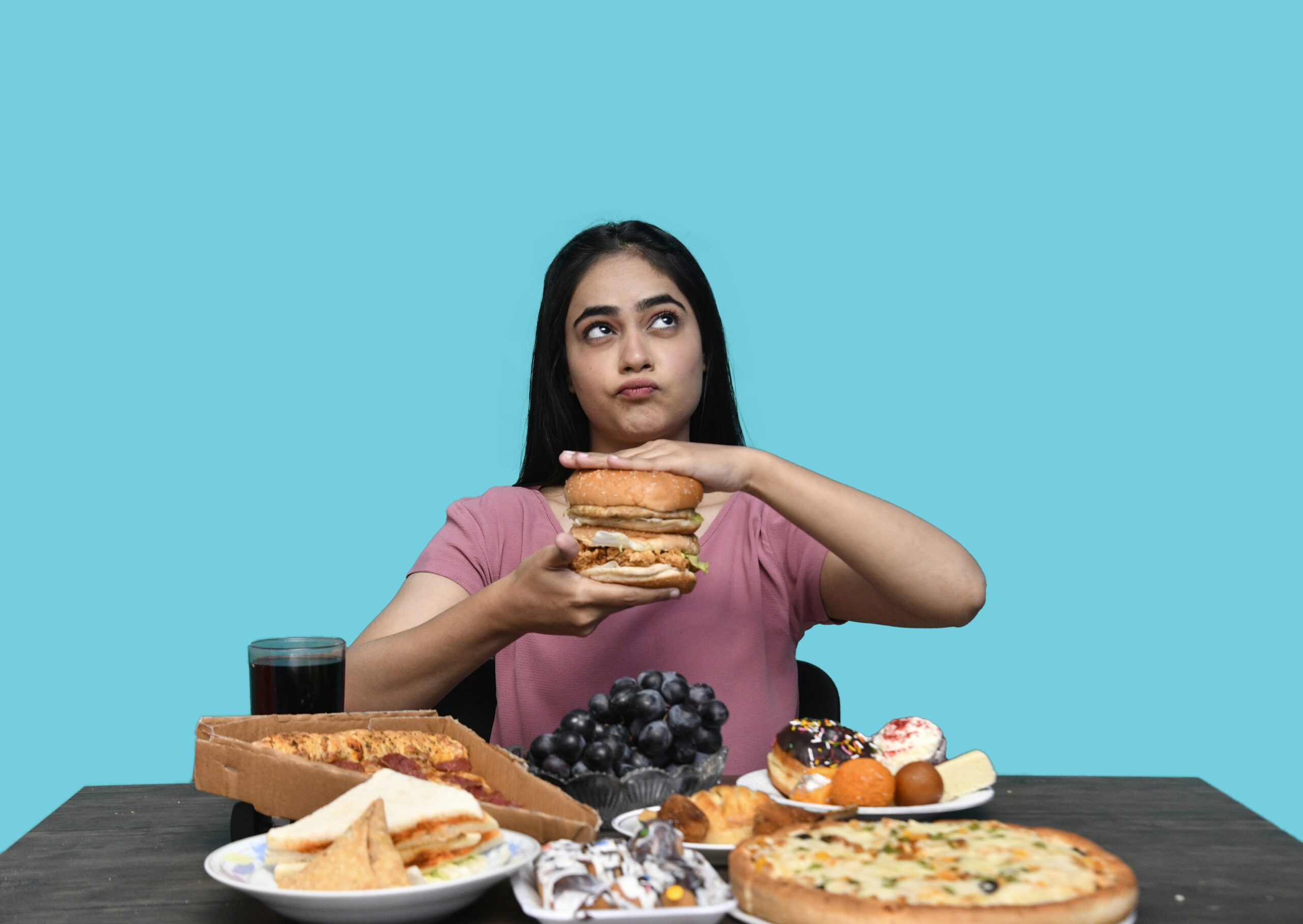 a woman holding a burger