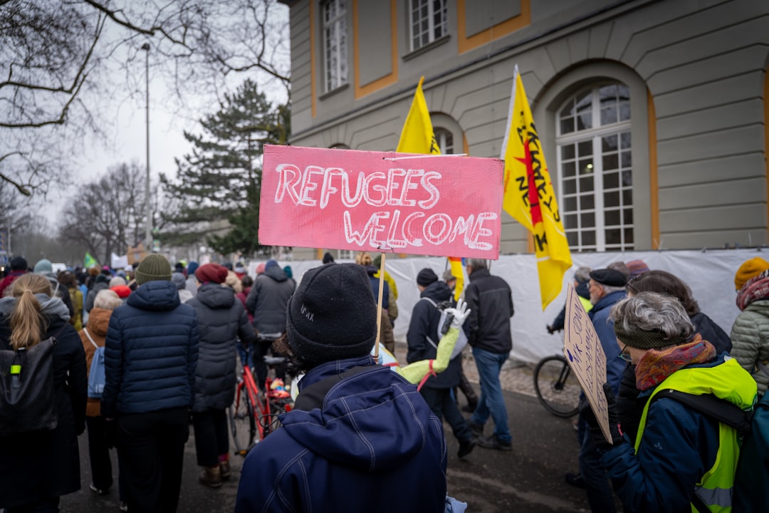 A large group of people holding signs in front of a building
